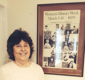 Molly Murphy MacGregor, with a poster from Sonoma County's first Women's History Week in 1977.